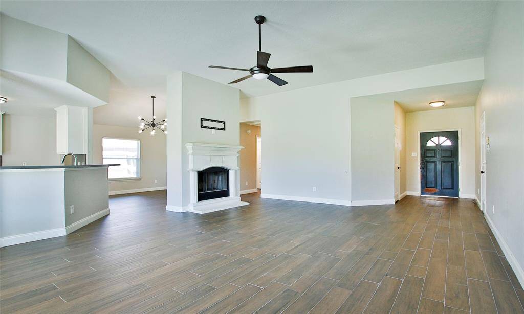 This gorgeous home features all wood look tile flooring throughout.