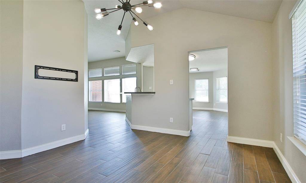 The dining room is located just behind the fireplace and has access to the kitchen.