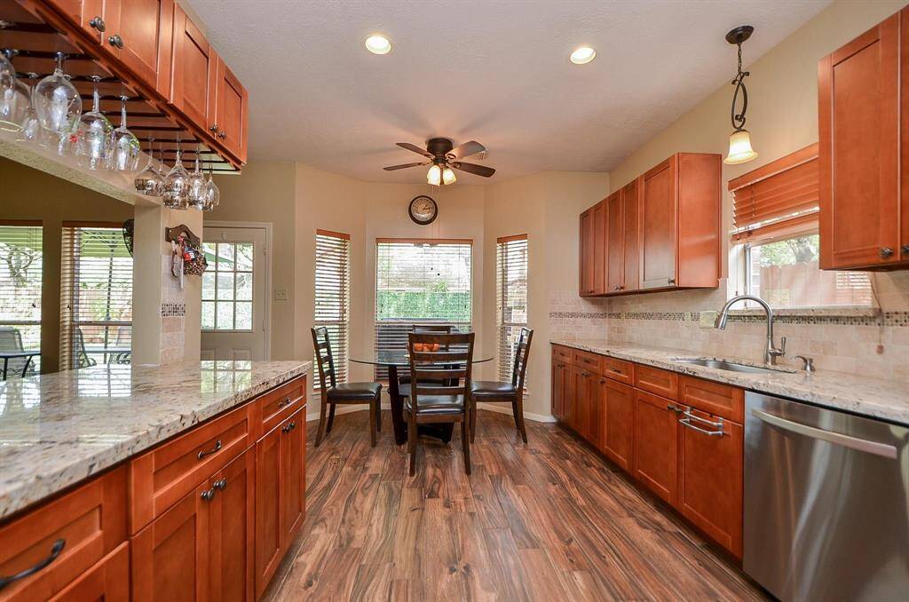 RECESSED, PENDANT, AND ADDITIONAL CEILING FAN LIGHTING IN BREAKFAST AREA. NOTICE THE MANY OPTIONS FOR CABINET STORAGE