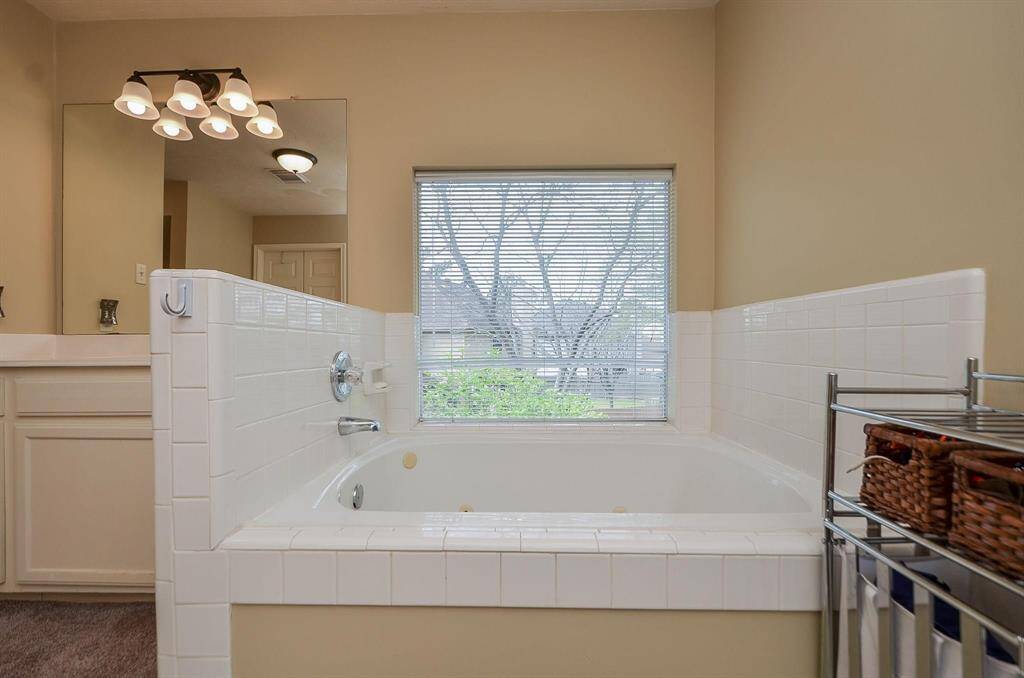 TILED GARDEN TUB WITH JETS, PUMP ACCESS DOOR AND A GREAT UPSTAIRS VIEW