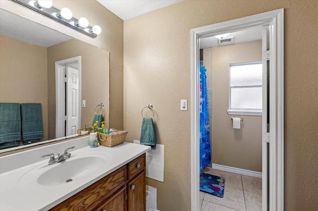 Shared hall bath with door separating sink areal for added privacy