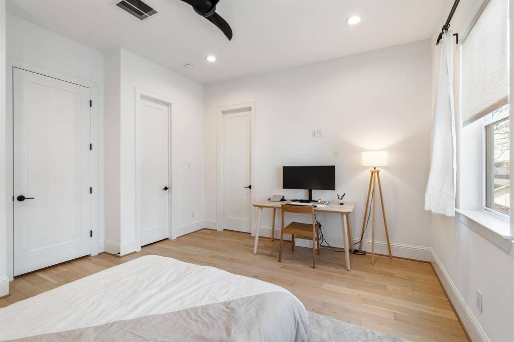 Another angle of the bedroom showcases its generous size, recessed lighting, and ample closet space. Ideal as a guest room or personal retreat.