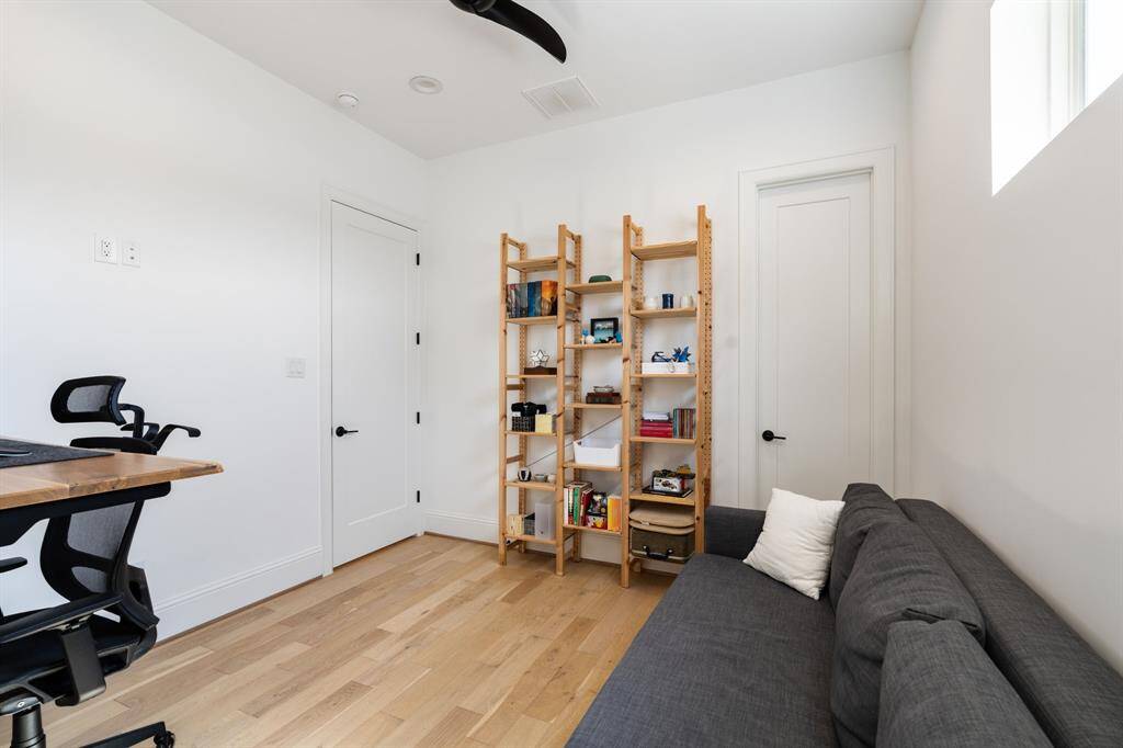 This perspective highlights built-in shelving and a private entrance, adding functionality for remote work or hobbies.