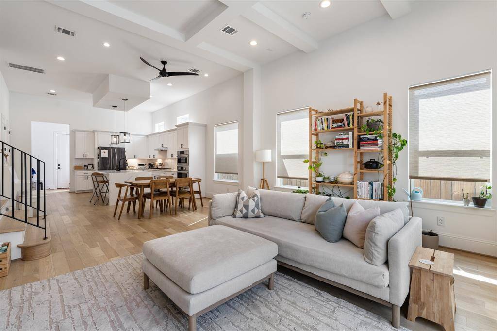 The seamless open-concept layout connects the living, dining, and kitchen spaces, offering a perfect setting for entertaining. High ceilings and modern architectural details create an effortless flow from room to room.