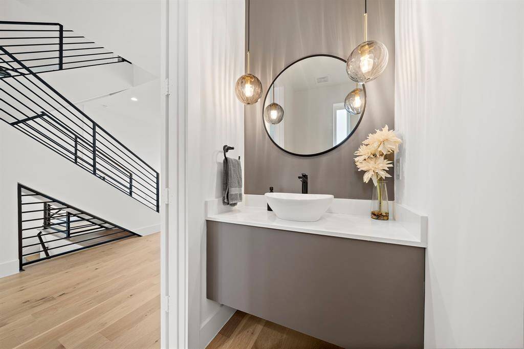 Strategically placed feature lights create a warm, inviting glow, transforming the powder room into a tranquil retreat.