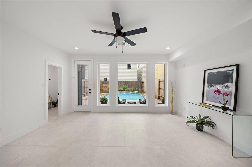 This stylish and functional modern room offers stunning pool views and versatile space for entertaining, a home gym, guest room or relaxation. Large windows bring in natural light, creating an open, atmosphere perfect for any use.