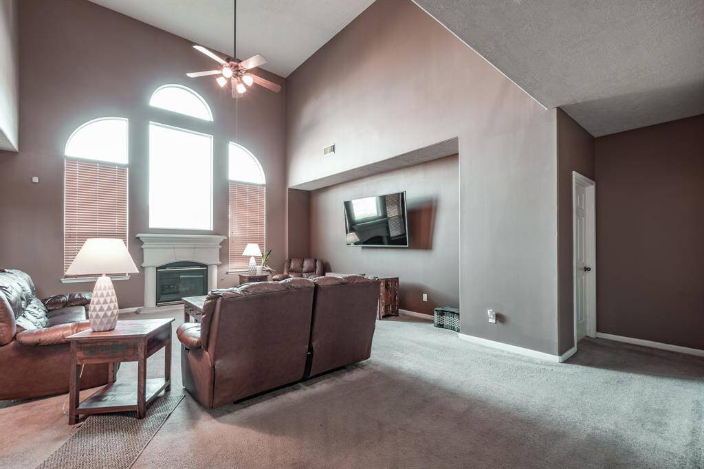 High vaulted ceilings and tall windows in living room