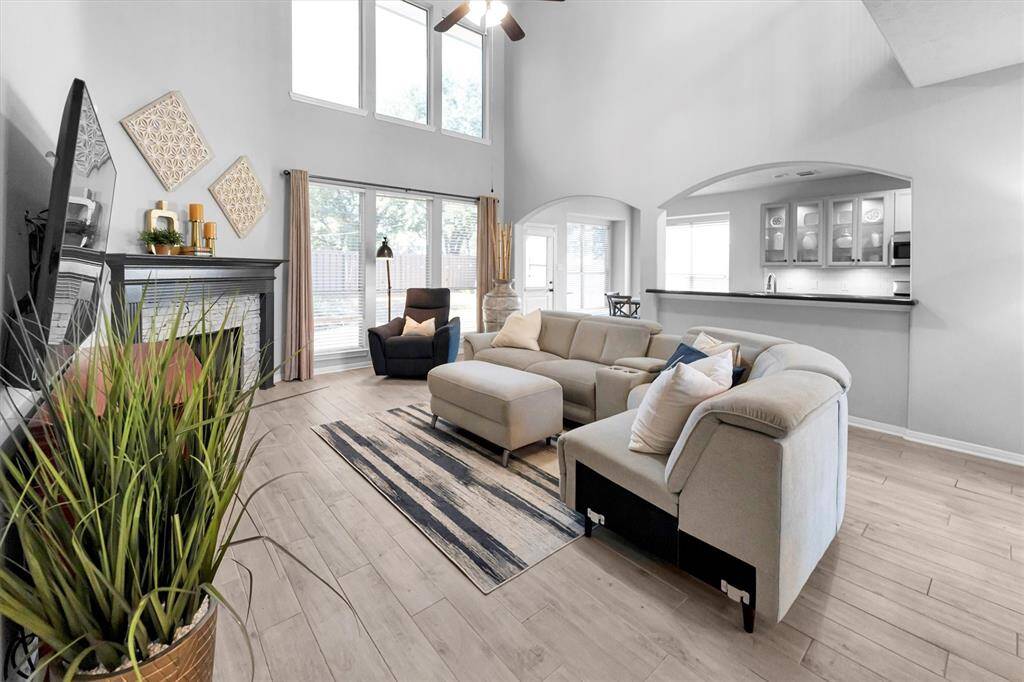 Spacious family room with soaring ceilings and views of private fenced backyard