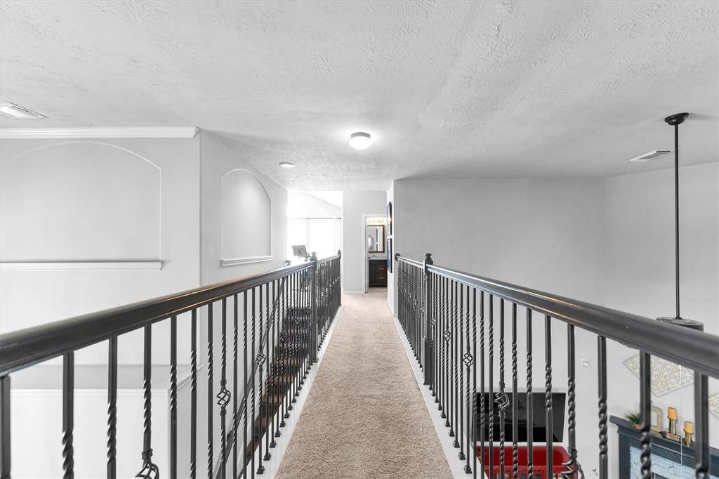 Extended walkway leading to another full bath and 2 generous size bedrooms