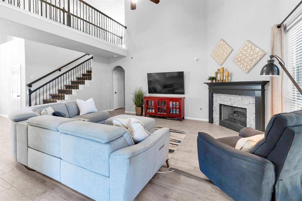 A large living area with brick fireplace is a cozy spot to relax or to entertain.