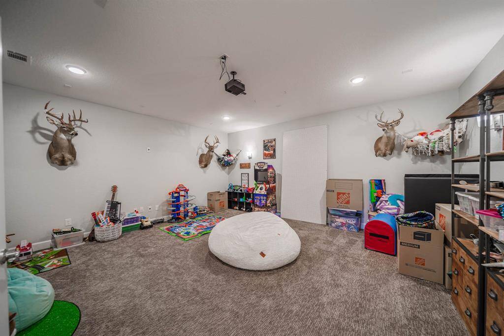 Media room is prewired for surround sound, projector staying and doubles as a play room!