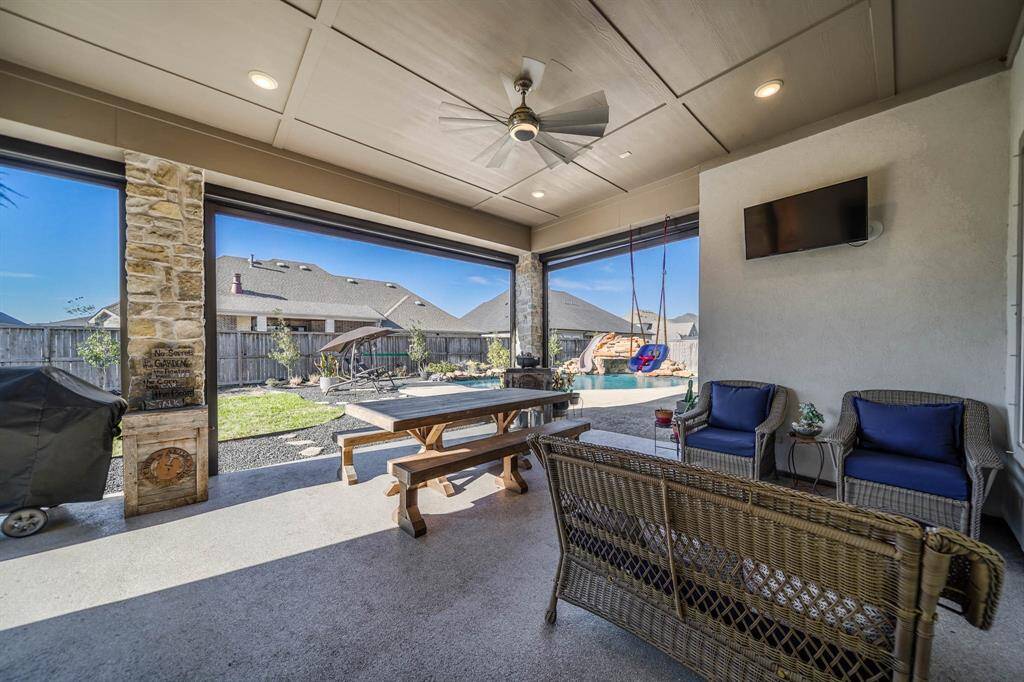 Spacious Outdoor Patio Area with Electric Shades, Pool Bathroom and water & gas hookup for outdoor kitchen.