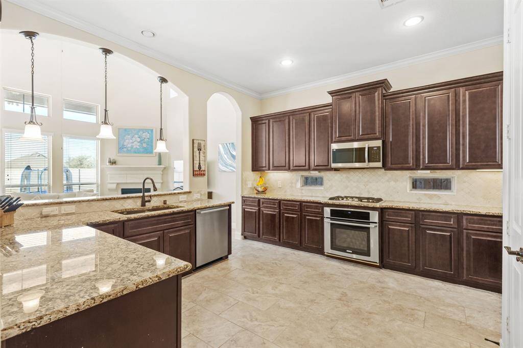 Chef’s Dream (and Your Reality) – This sophisticated and spacious kitchen comes with rich dark cabinets, shiny stainless steel appliances, and countertops so big, you’ll wonder if you’re cooking for an army or just making dinner for two. Either way, you’ll feel like a culinary genius!