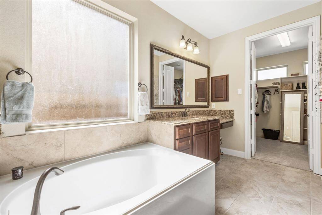 Soak with a View – This large bath in front of a huge window gives you the perfect opportunity to relax while pretending you're in a luxury spa commercial.