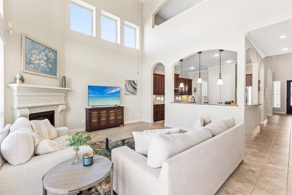 This grand living room comes with soaring 20-foot ceilings—because why settle for normal when you can feel like you're living in a ballroom? Perfect for both relaxing and pretending you're hosting a gala.