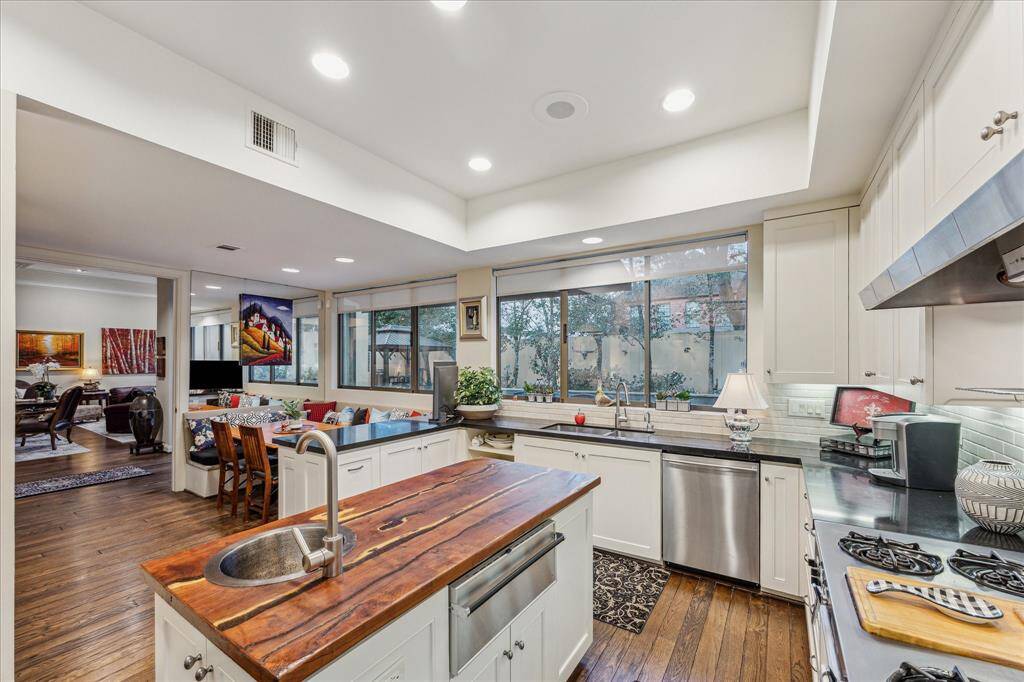 KITCHEN II-Another view of the kitchen area open to the breakfast space and living room. This space also features great storage and beautiful views to the outdoors. Ther is also a warming drawer and new Instahot water dispenser at the kitchen sink.