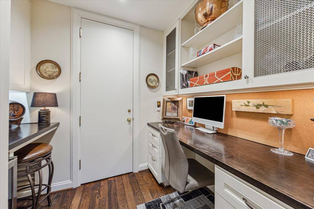 The built in desk area and bar is located just off the kitchen. The desk space is the perfect place to pay bills and features a wood stained top, cork board backsplash and custom wire mesh cabinet fronts. The bar area also features a recent wine cooler.