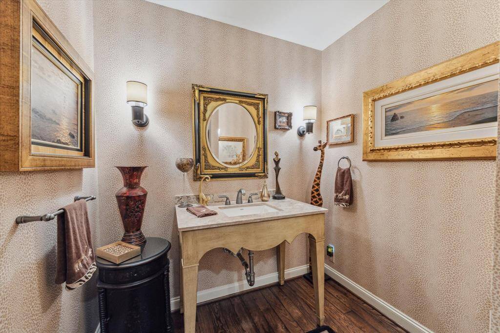 POWDER ROOM-This sexy and fun power room feature animal print walls and an artistic vanity with limestone countertop.