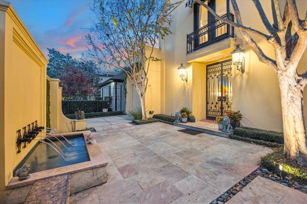 Behind the privacy wall, you will find a soothing free flowing fountain. Make note of the large patio space which is perfect for parties. The home also features an outdoor camera monitoring system with remote access.