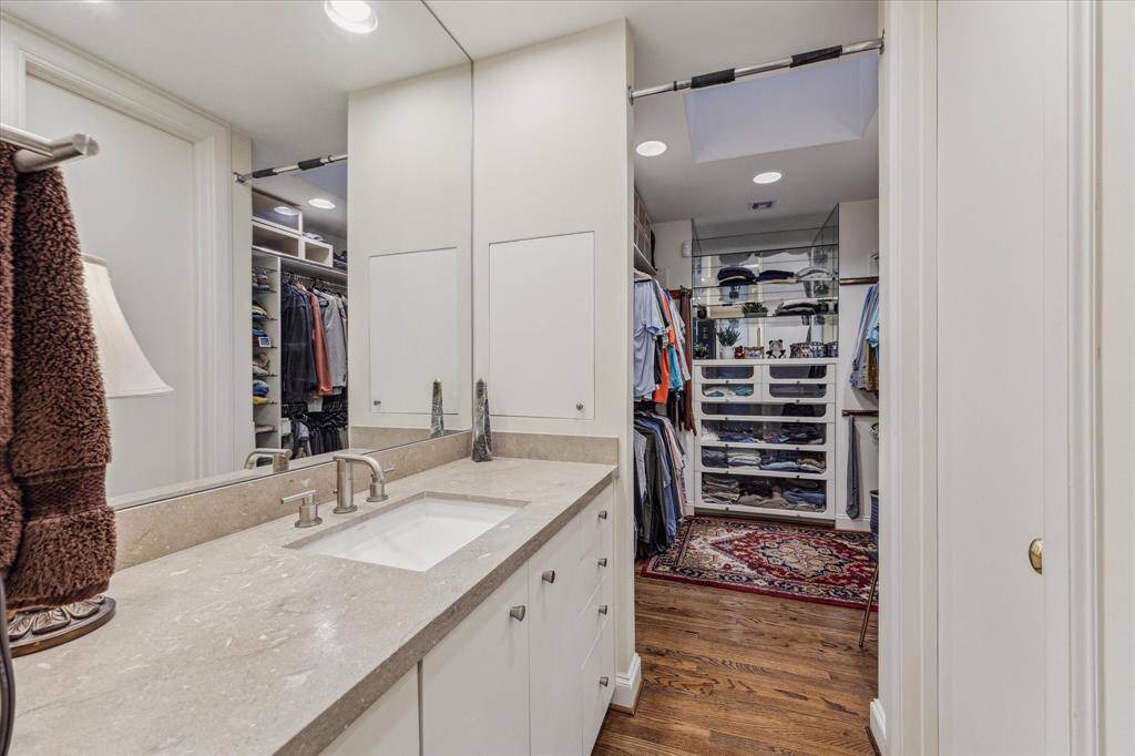 PRIMARY BATHROOM II-This separate vanity space features limestone countertop and a private walk-in closet with built-ins.