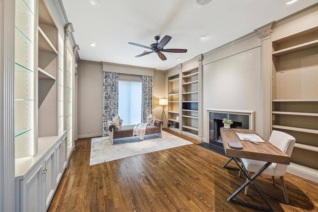 LIBRARY/OFFICE-This handsome space features a gas log fireplace, wood floors, built-ins and beautiful millwork. This spacious room could also be used as a third bedroom if needed.