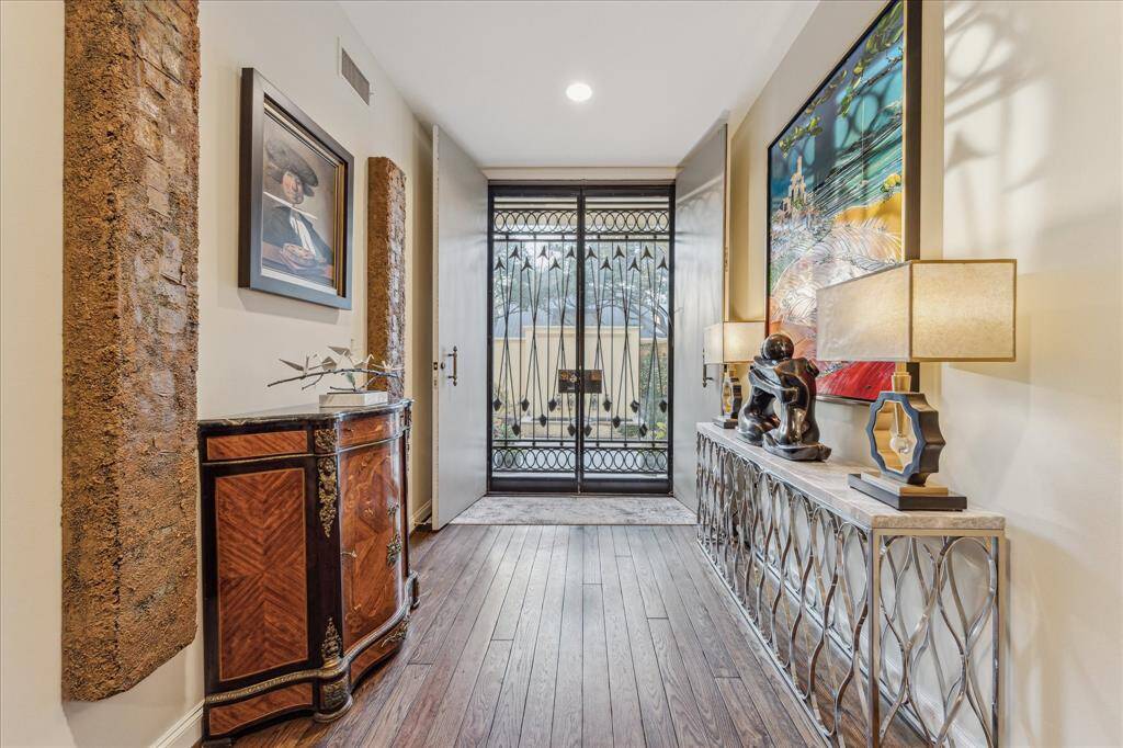 FRONT ENTRY-The formal entry features double doors as well as artistic custom iron gates.