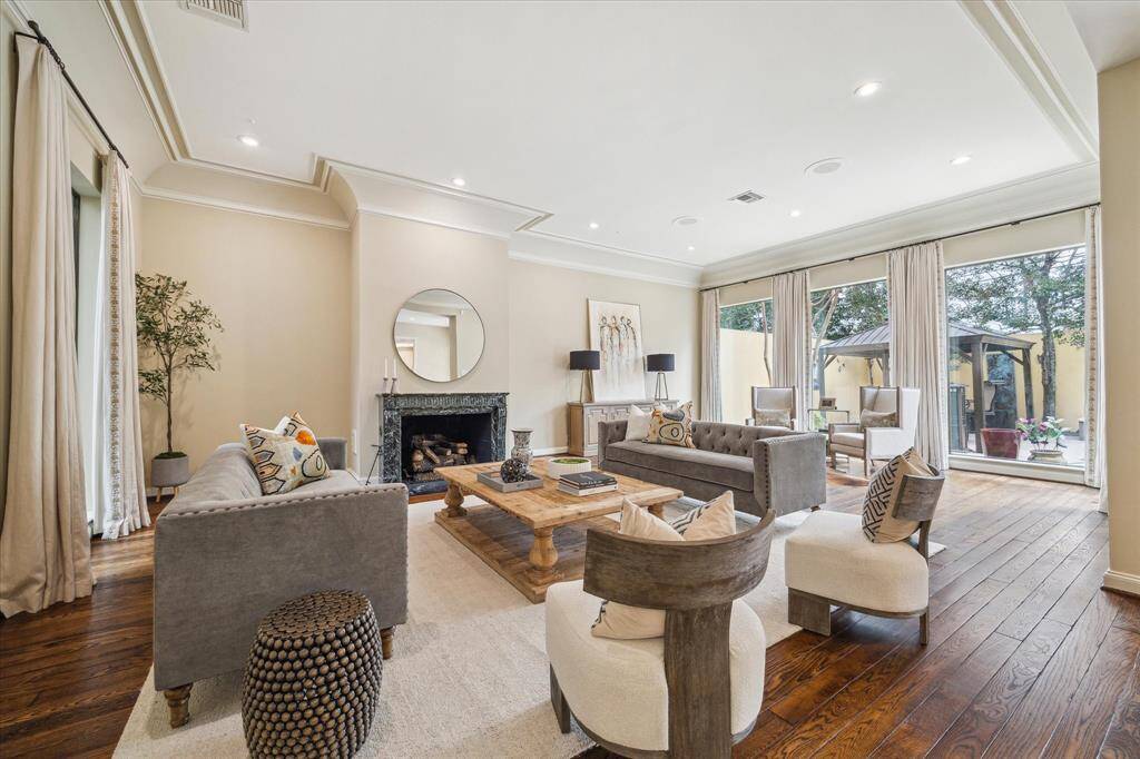 LIVING AREA-This swanky space has a stunning gas fireplace with marble surround and beautiful oak wood floors.