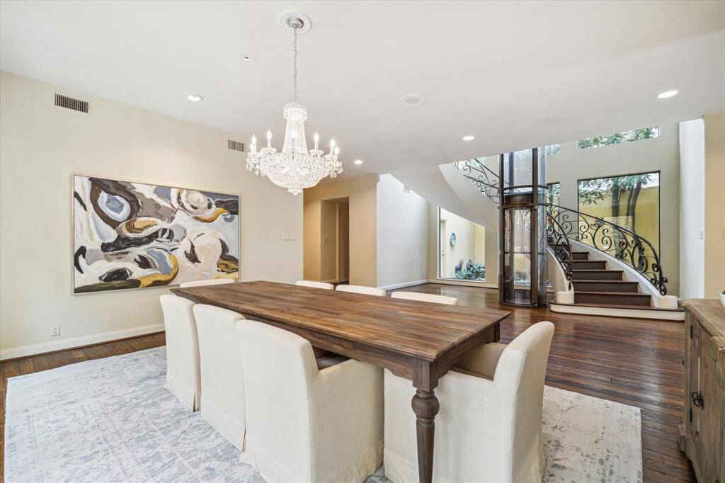 DINING ROOM II-Another perspective of the dining area which is nice and open and also features a beautiful glass chandelier. The flow of this home is perfect for entertaining guests.