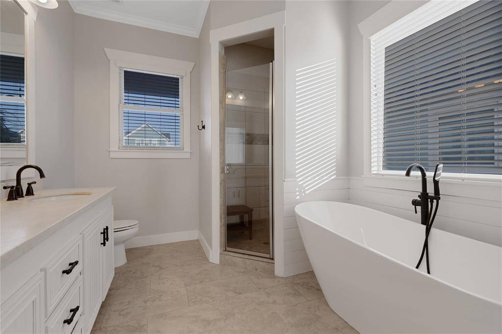 Primary unsuite with standup shower and soaking tub.