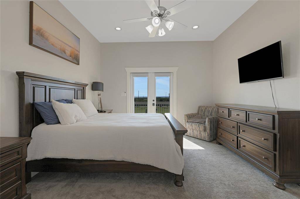Primary bedroom on the 2nd floor with an unsuite attached.  Through the double doors is a deck area to watch the sun set on the ocean side.
