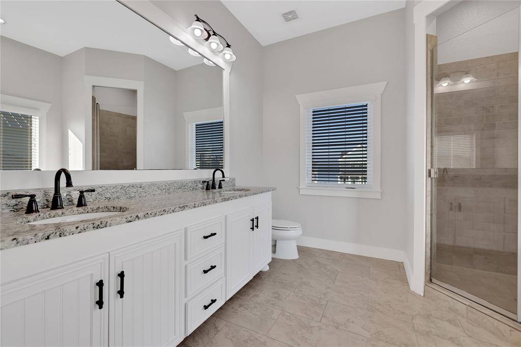 Primary unsuite with shower and soaking tub.