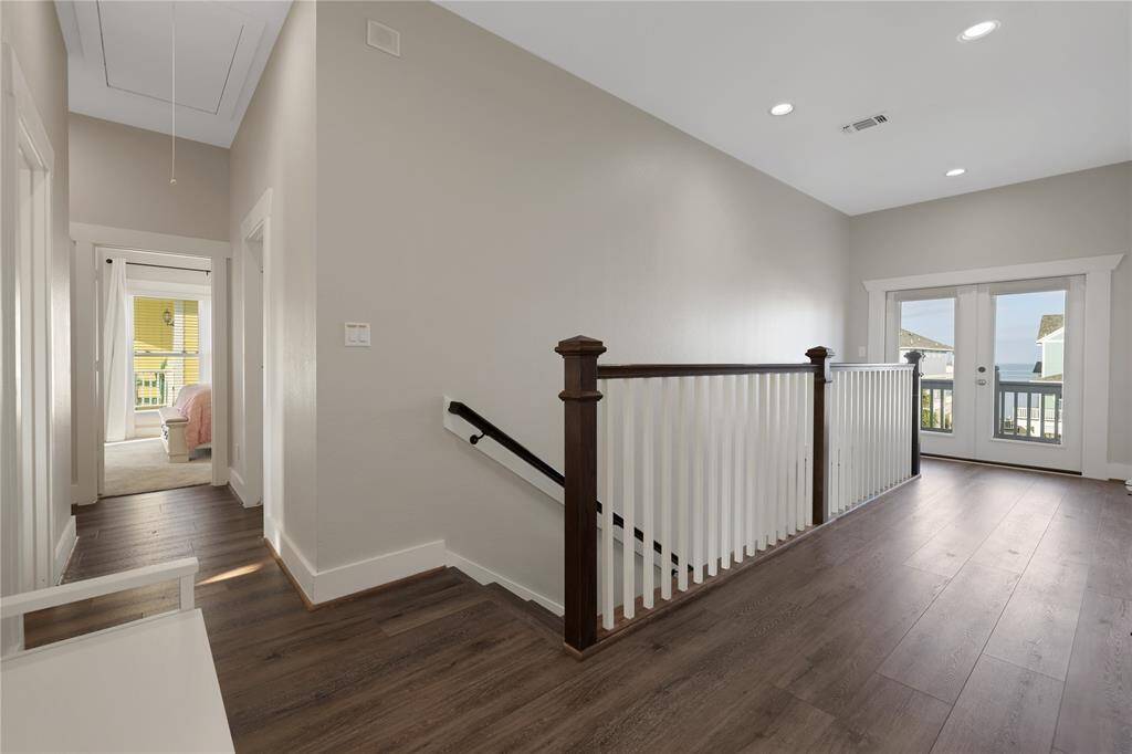 Upstairs landing with access to the upstairs bedrooms.  Leads to another deck area with a bayside view.