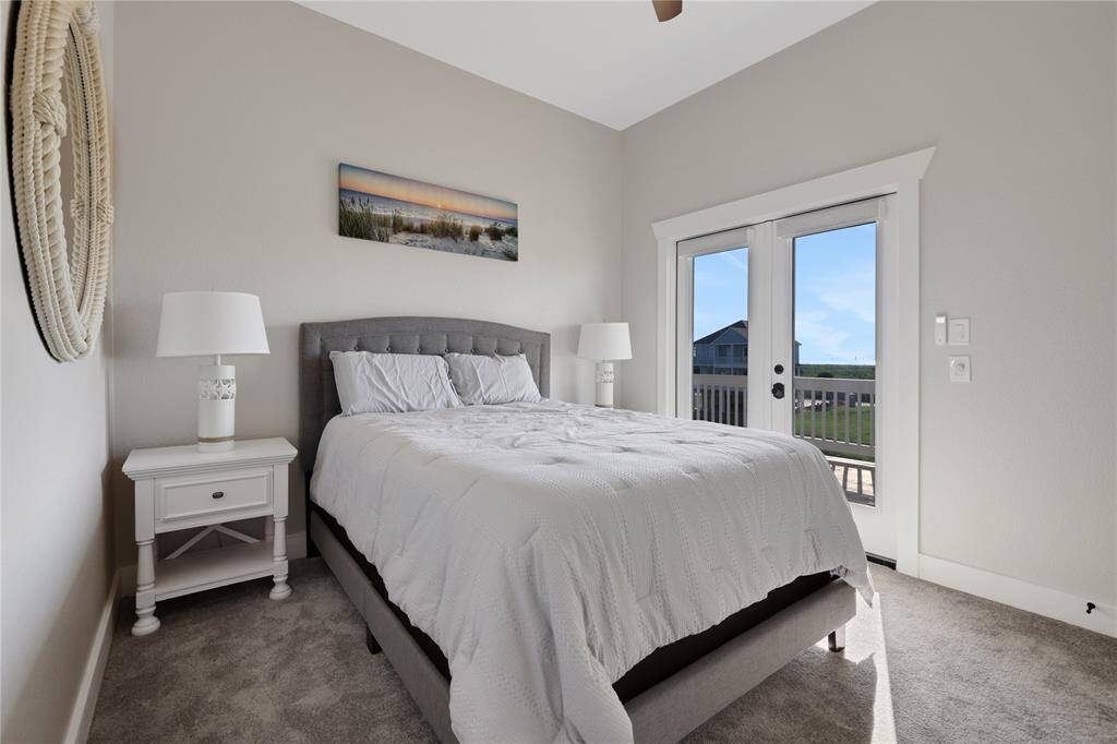 5th bedroom with double doors open to the ocean side view.