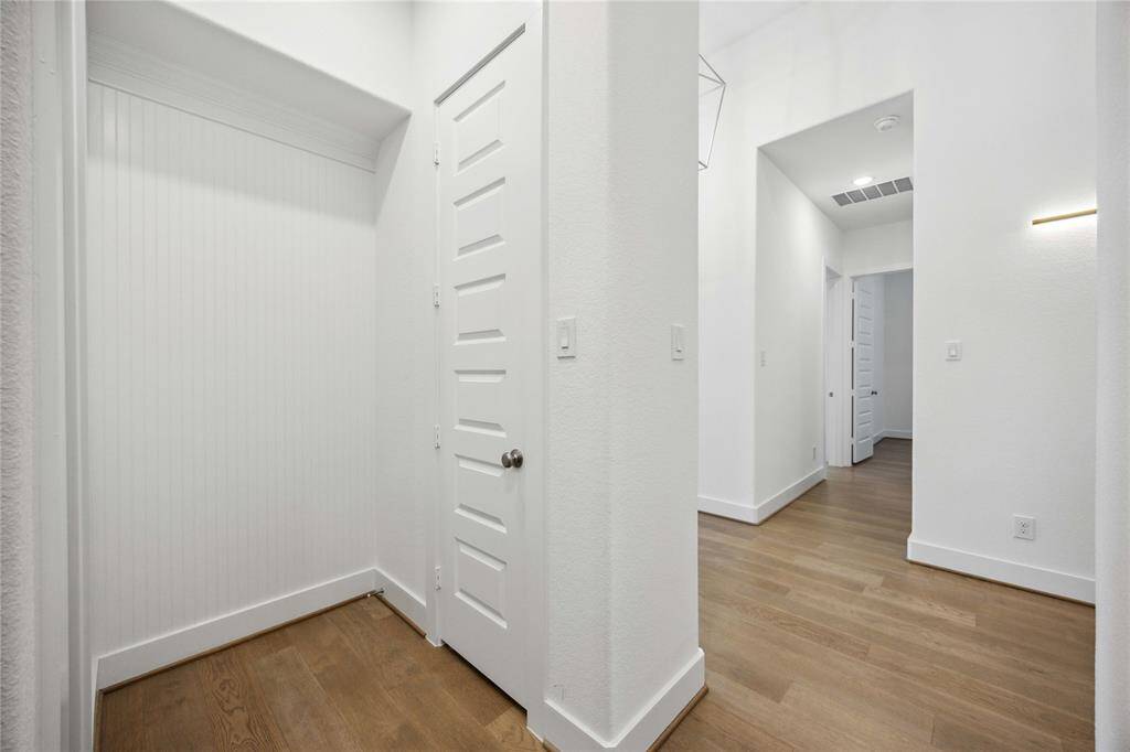 View back garage entry showing mudroom space and coat closet