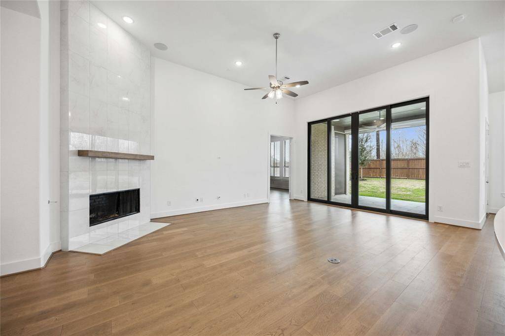 Bright and airy living room with fireplace and slider access to the covered patio.