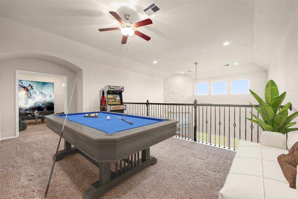 Perfect for entertaining is this amazing game room!  Right upstairs this space would be a fabulous teen hangout, or adult game room complete with pool table and big screen TVs. Featuring plush carpet, high ceilings, dark stained ceiling fan, neutral paint and open to the downstairs.