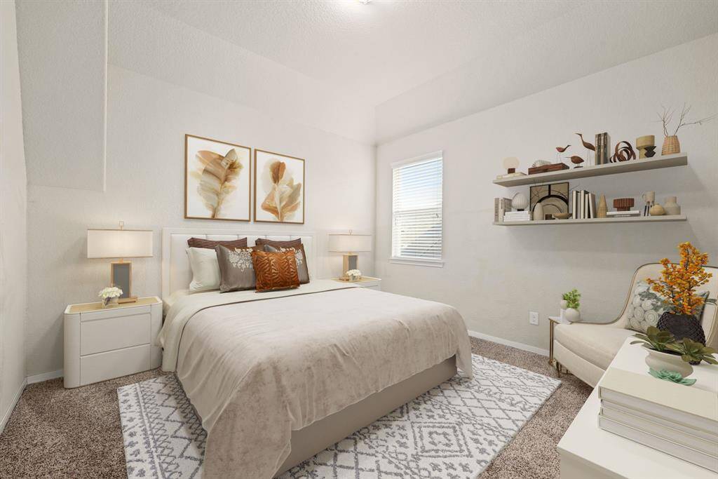 Secondary bedroom features plush carpet, neutral paint, raised ceilings, lighting and a large window with privacy blinds.