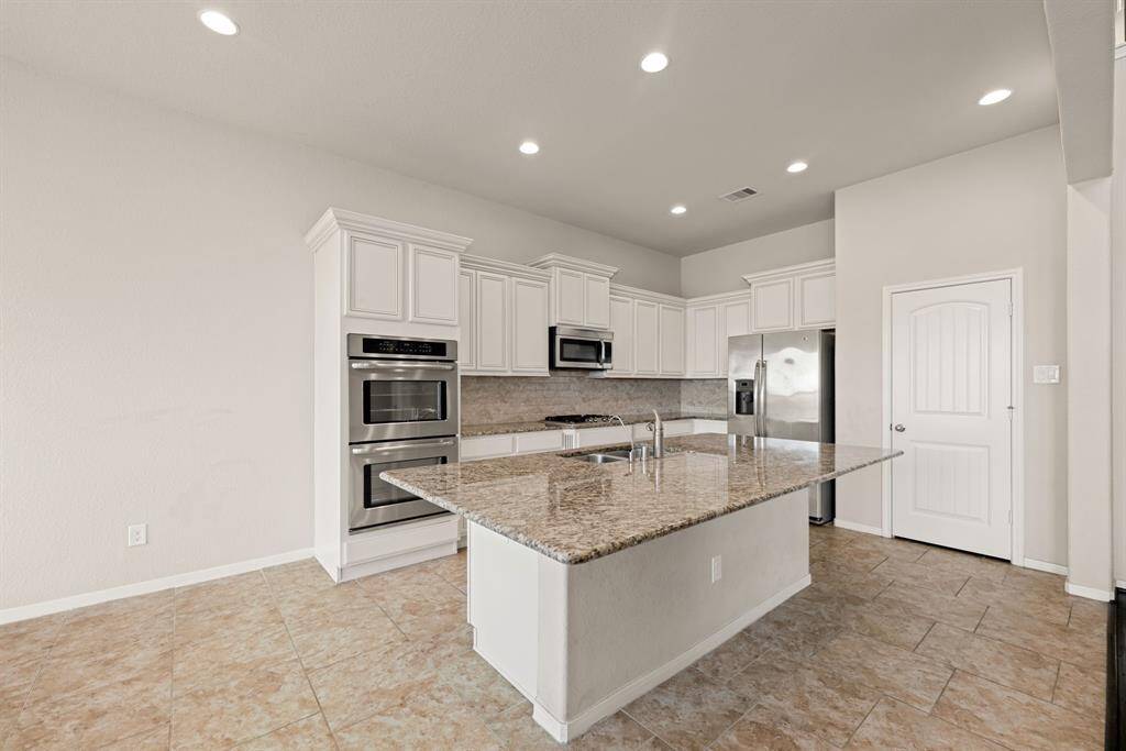 Any chef's dream, this stunning kitchen is perfect for everyday life as well as entertaining family and friends! Extra large kitchen island is perfect for conversation or that much needed space to lay out your party spread for everyone to enjoy! Large windows provide lovely views of your backyard and plenty of natural lighting throughout the day.