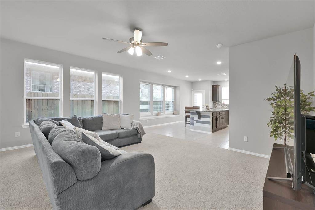 This spacious open-concept living area features a large, comfortable seating area, perfect for entertaining
