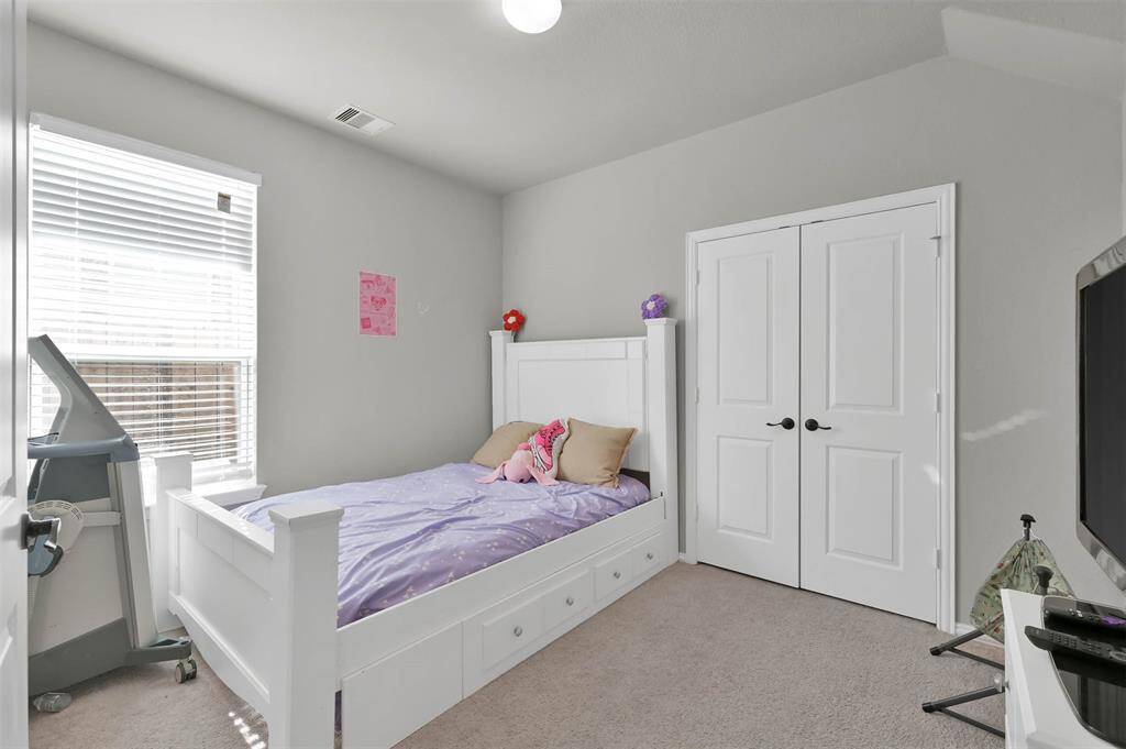 This cozy additional room downstairs features a double-door closet & a window allowing natural light creating a comfortable atmosphere, ideal for a home office or guest room