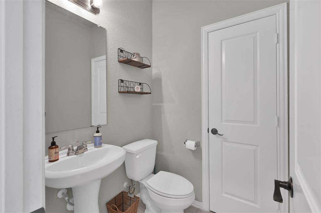 First floor features a clean, modern-styled half bathroom