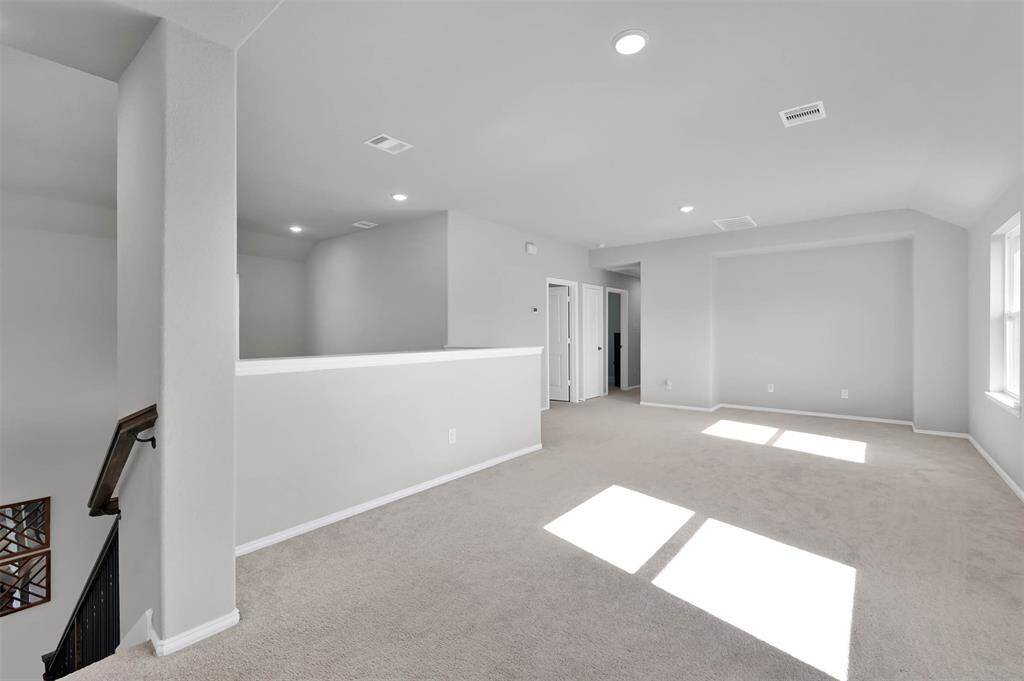 This is a bright, open-concept upper floor space/game room with recessed lighting & ample natural light from large windows