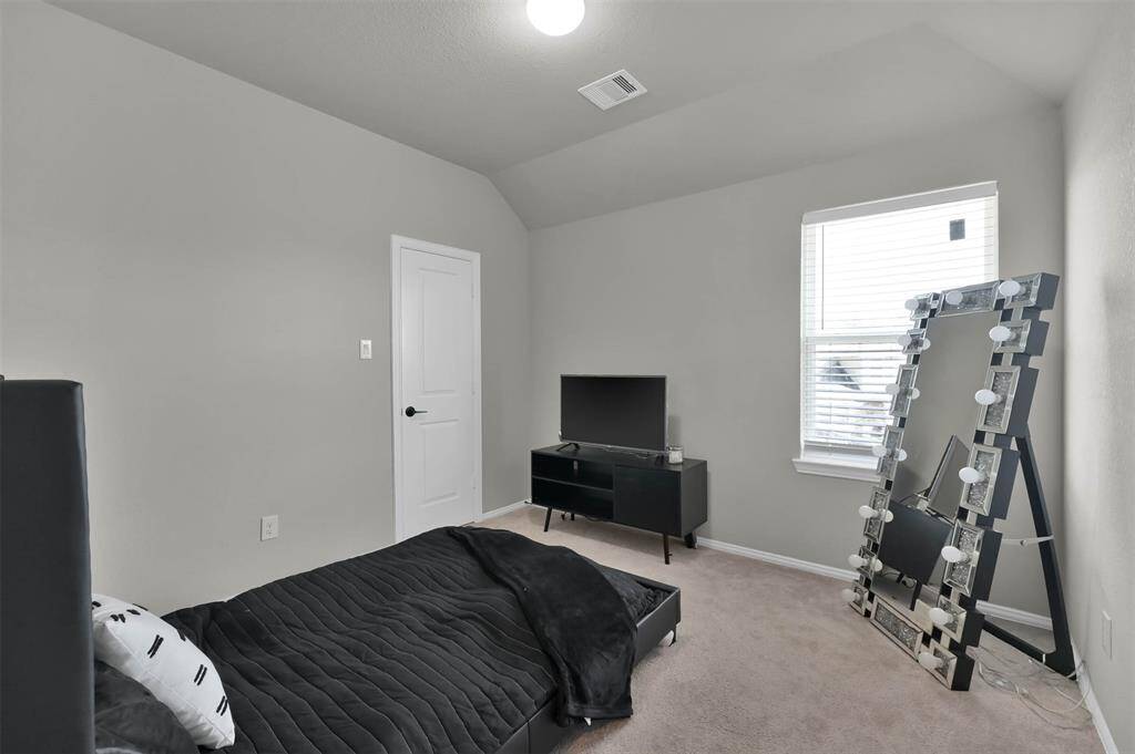 Upstairs guest BR #3 - sleek bedroom features  ample natural light creating a comfortable & functional space