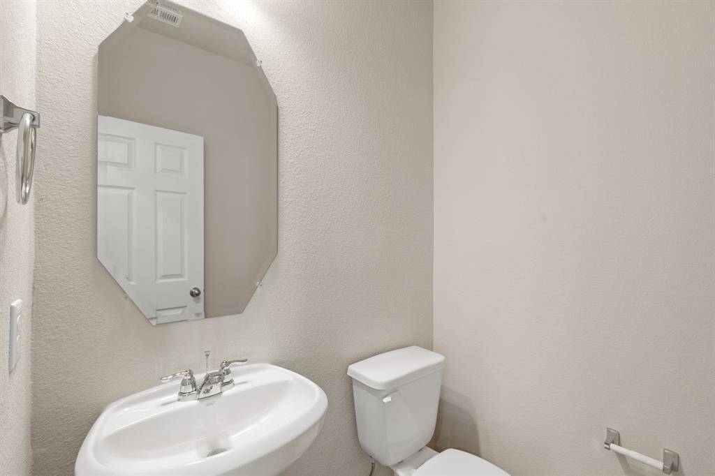 This charming home features a beautifully appointed half bath adjacent to the family room, perfect for welcoming guests and adding convenience to your daily life.