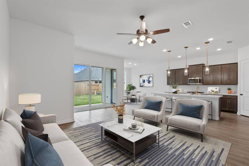This home boasts a spacious open concept layout that combines the best of modern design and comfort for everyday living. Photo is virtually staged