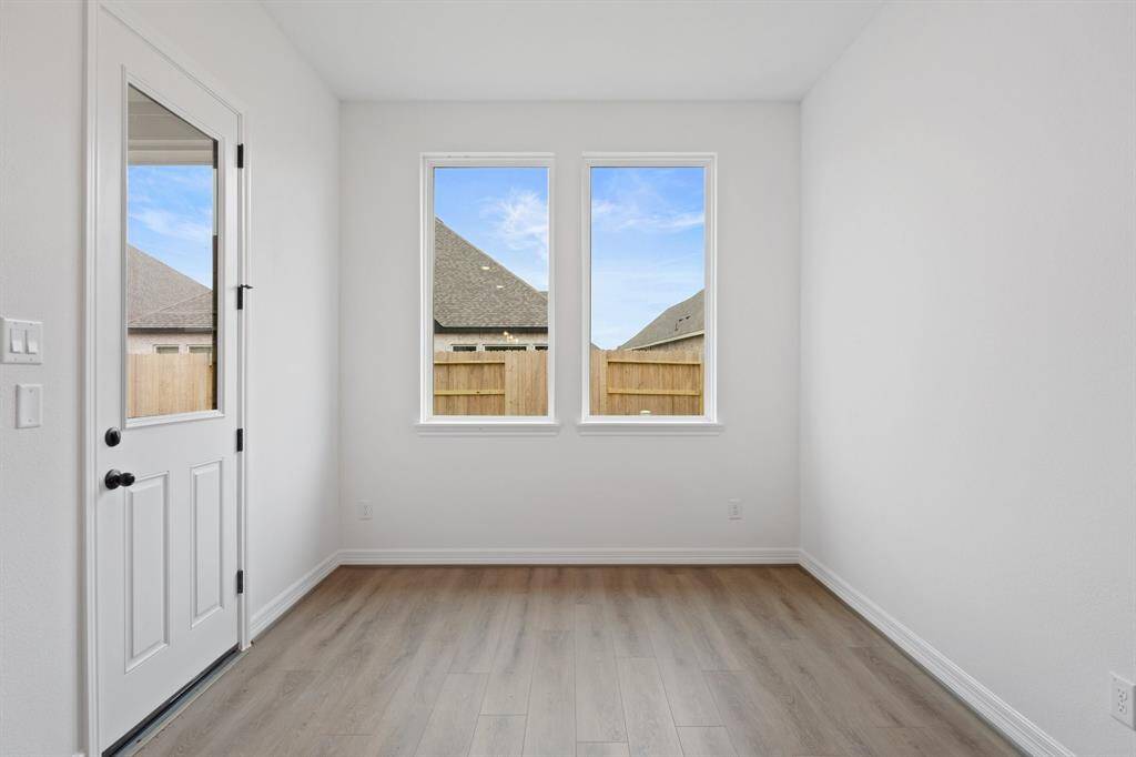 With an abundance of natural light streaming through the windows, the breakfast nook is bathed in a sunny glow, creating the perfect atmosphere to enjoy your morning coffee or a family breakfast.