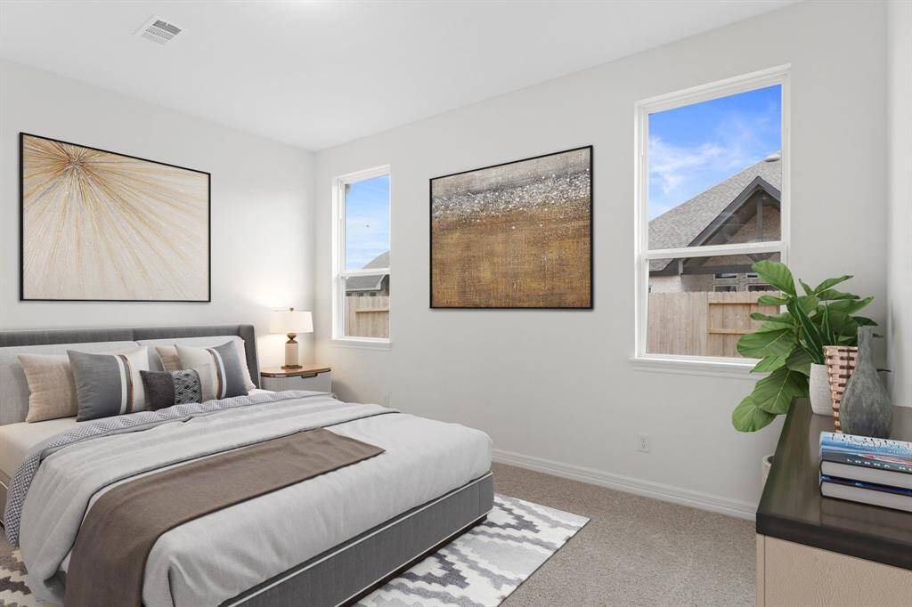The primary bedroom is generously sized, creating a tranquil and spacious retreat that offers ample room for relaxation. Featuring plush carpet, high ceilings, fresh paint, and large windows that lets in natural lighting throughout the day. Photo is virtually staged