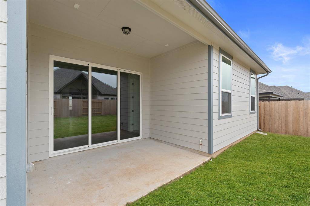 The covered patio is generously sized, providing ample space for various outdoor activities.