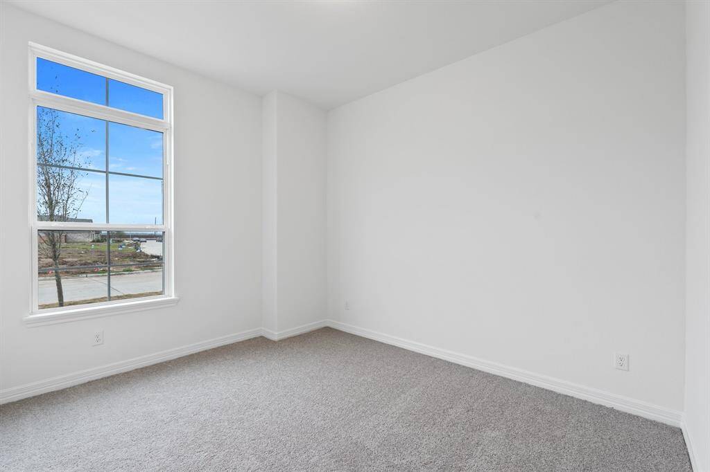 Your secondary bedroom features plush carpet, fresh paint, closet, and a large window that lets in plenty of natural lighting.