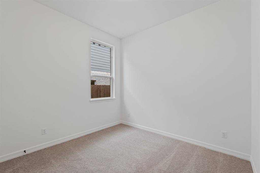 Your secondary bedroom features plush carpet, fresh paint, closet, and a large window that lets in plenty of natural lighting.